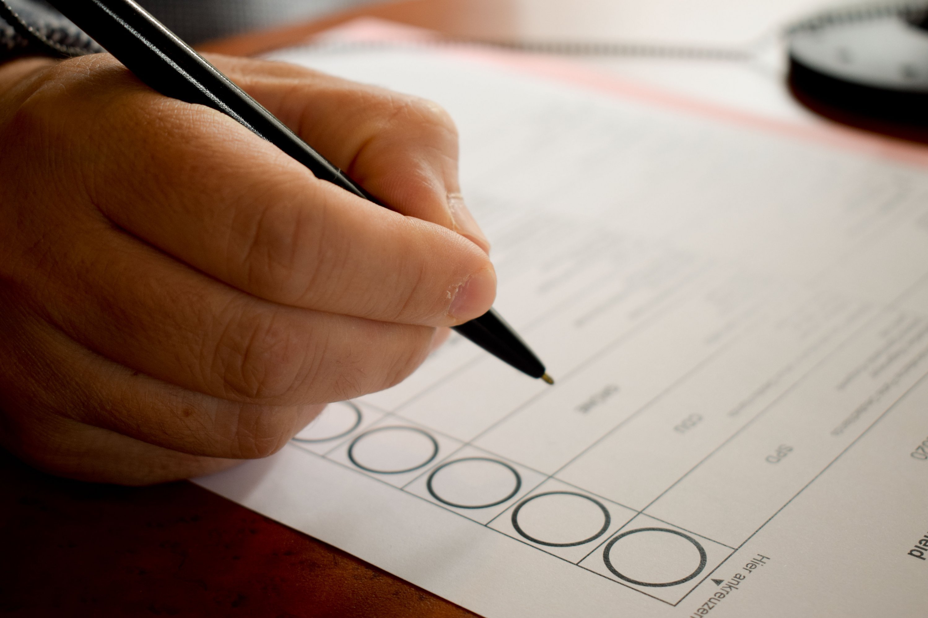 Jemand macht sein Kreuz auf einem Stimmzettel