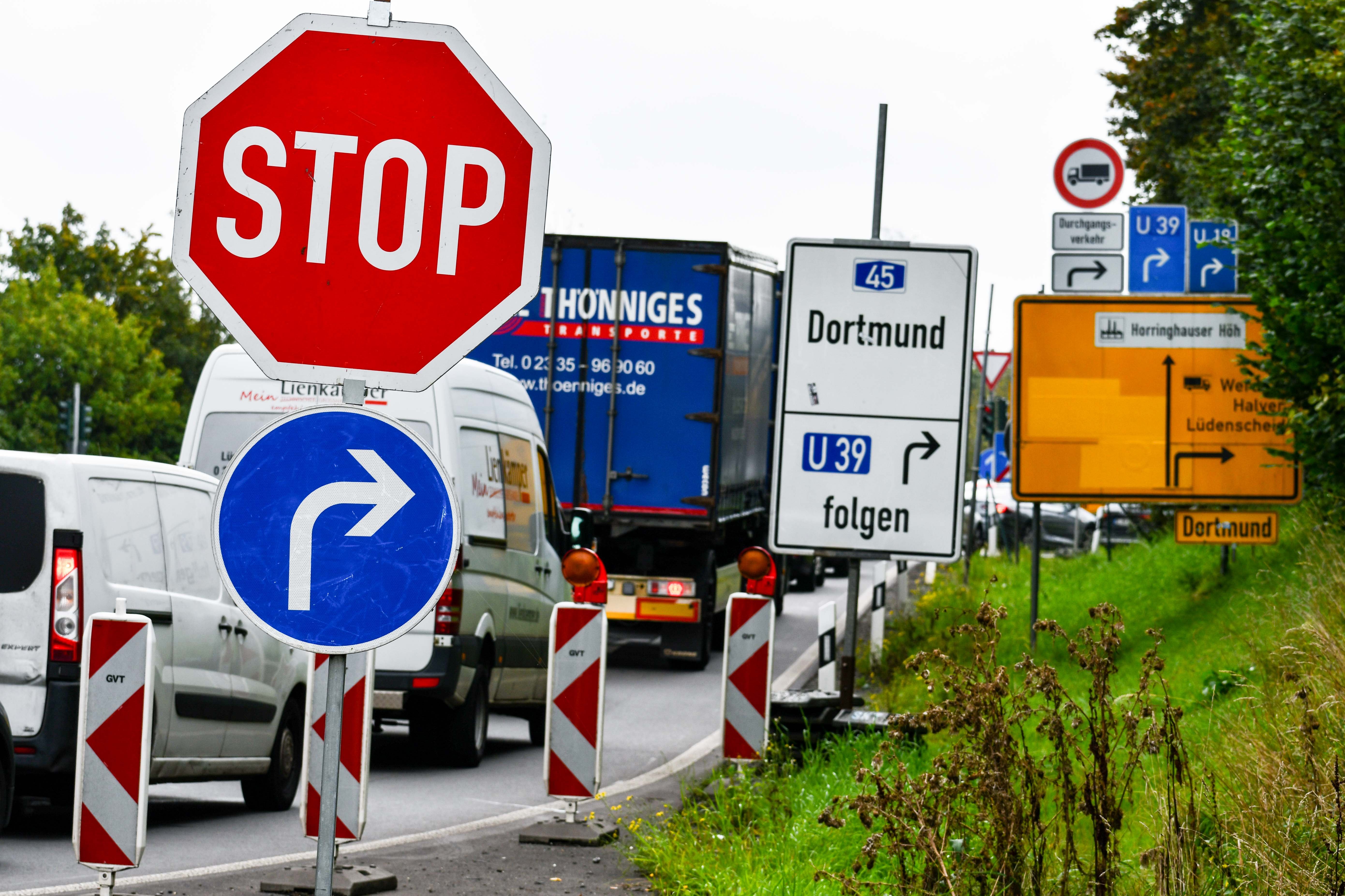 Verkehrsschilder neben einer viel befahrenen Straße